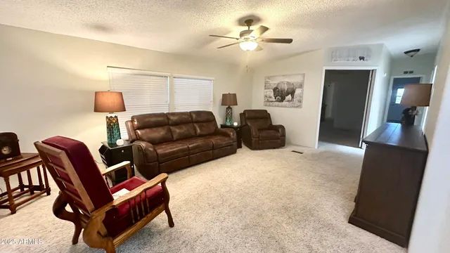 a living room with furniture a couch and a flat screen tv