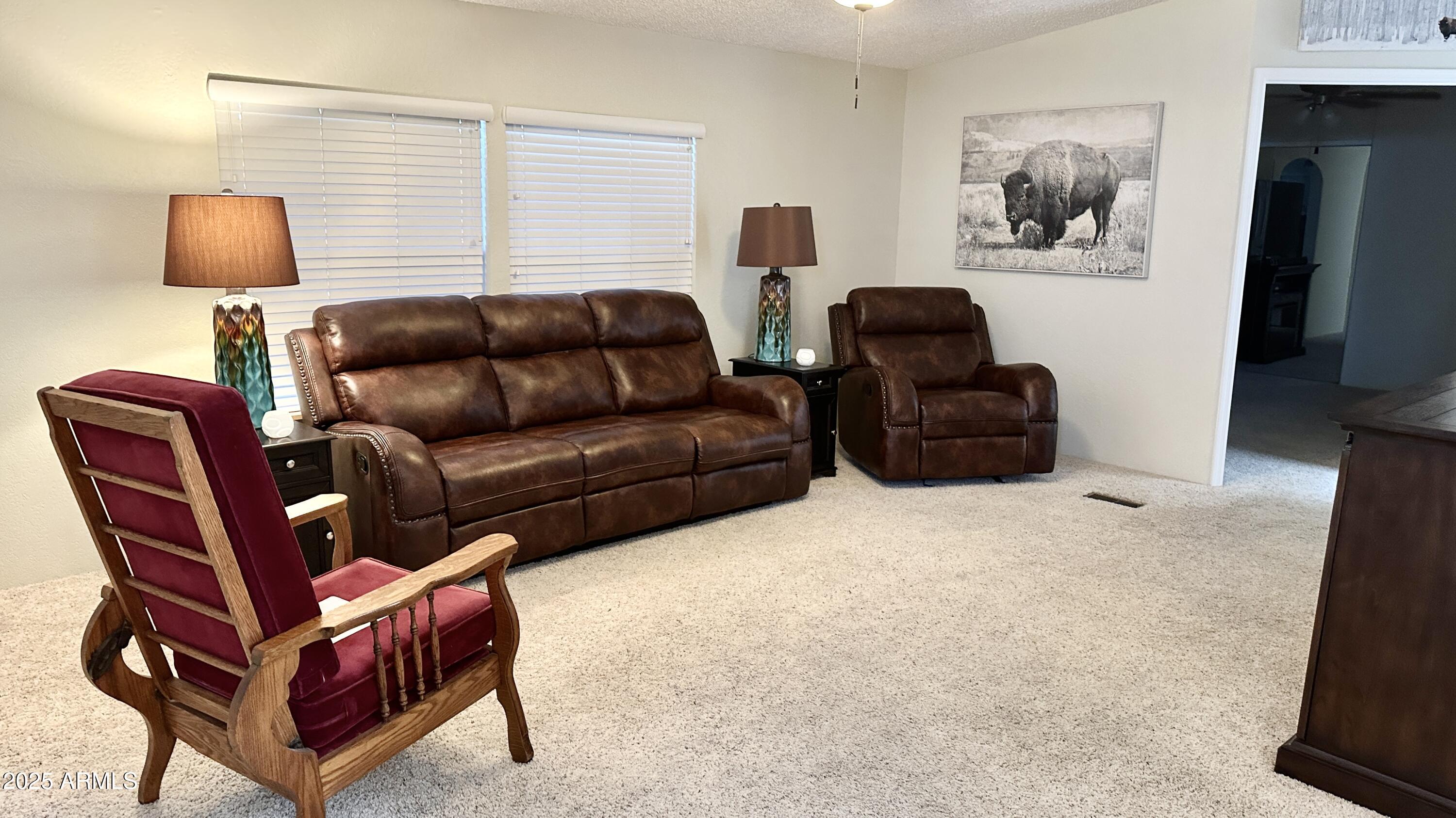 834 South Meridian Road, Unit 76 Apache Junction, AZ 85120 - Photo 29 of 50 a living room with furniture a couch and a flat screen tv