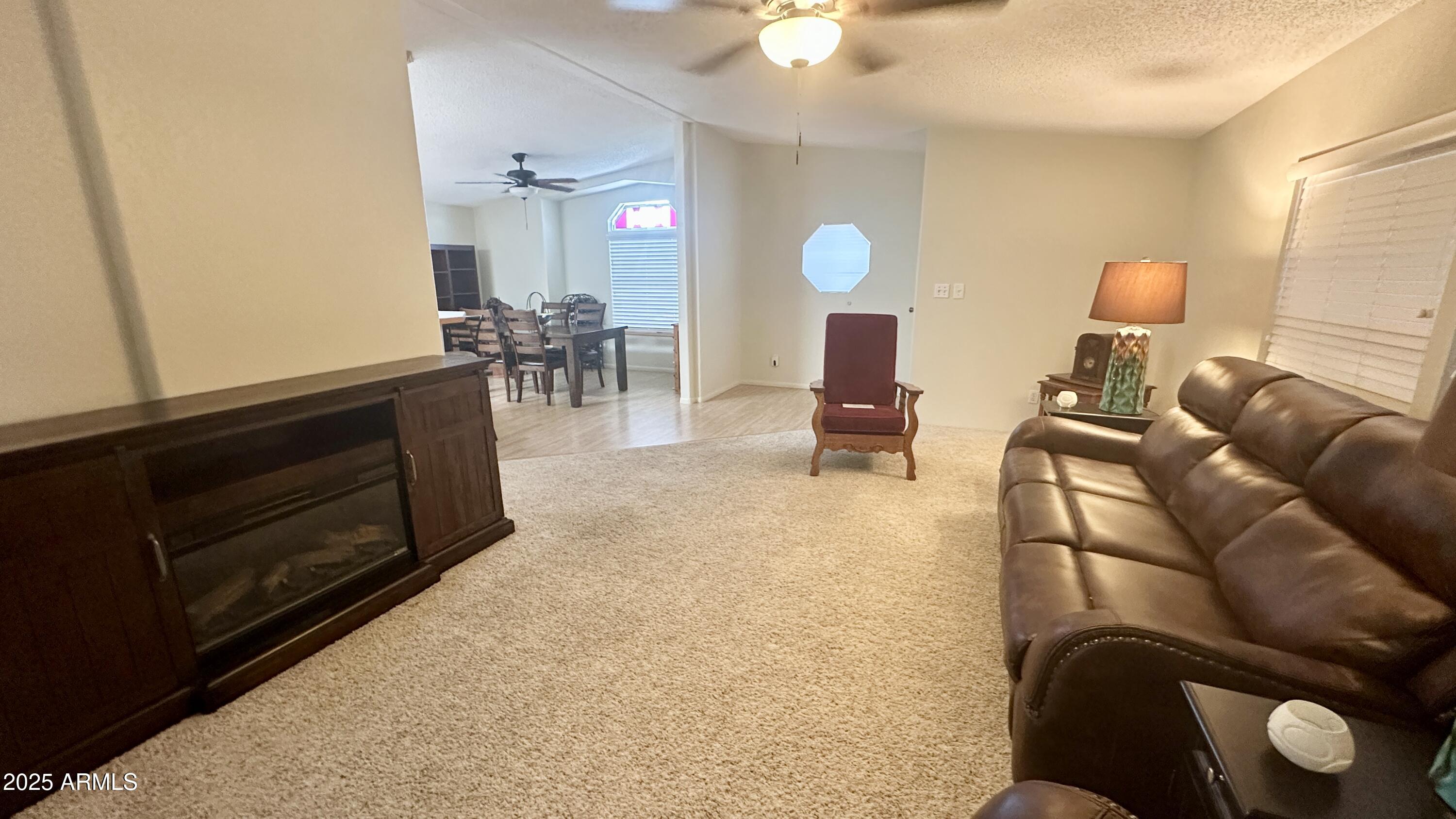 834 South Meridian Road, Unit 76 Apache Junction, AZ 85120 - Photo 30 of 50 a living room with furniture and wooden floor