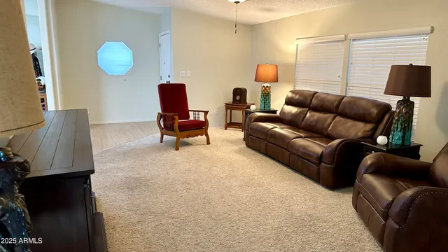 a living room with a bed furniture and a window
