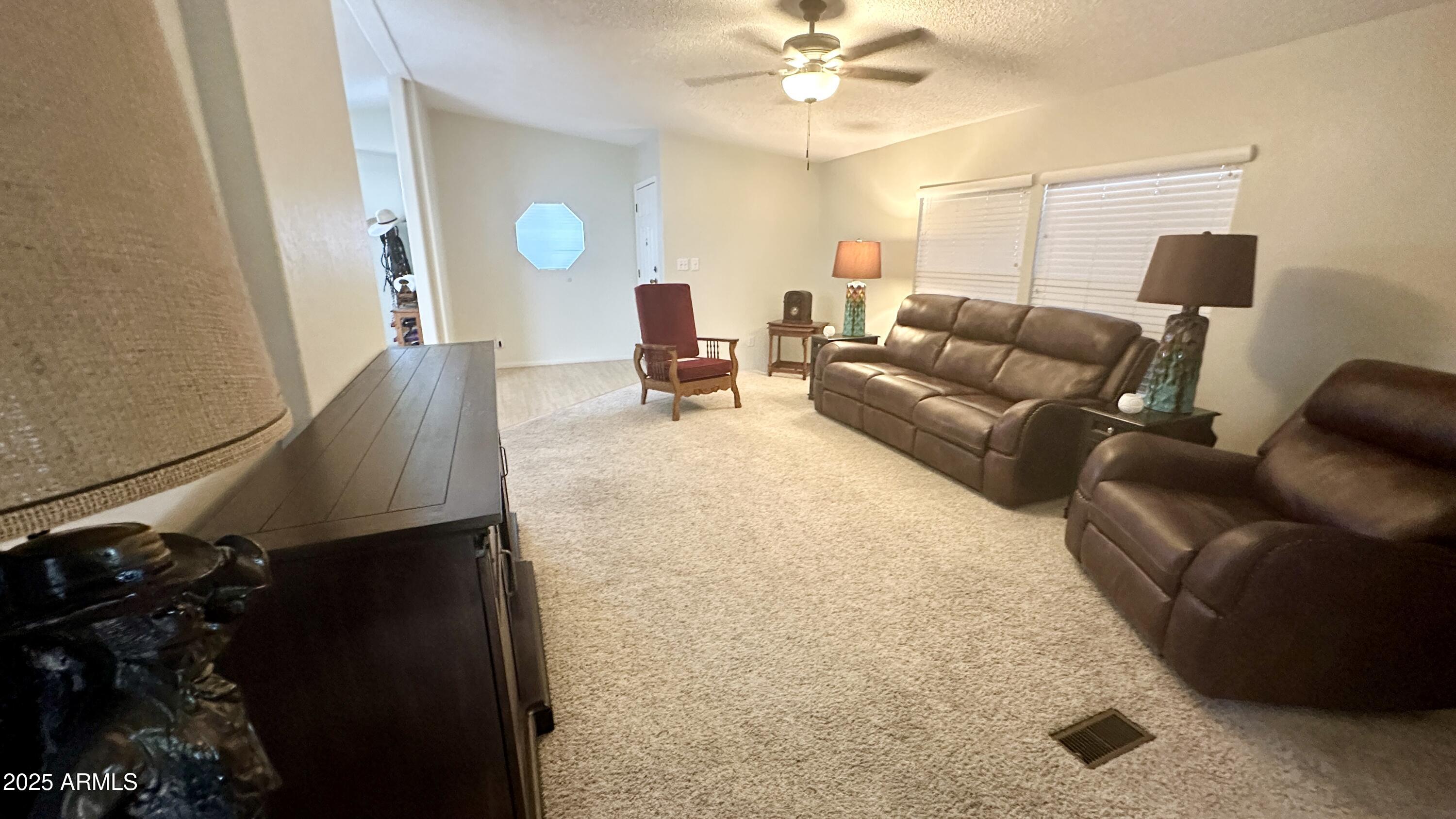 834 South Meridian Road, Unit 76 Apache Junction, AZ 85120 - Photo 32 of 50 a living room with furniture and wooden floor