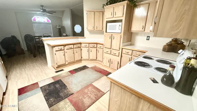 a kitchen with white cabinets sink and stainless steel appliances