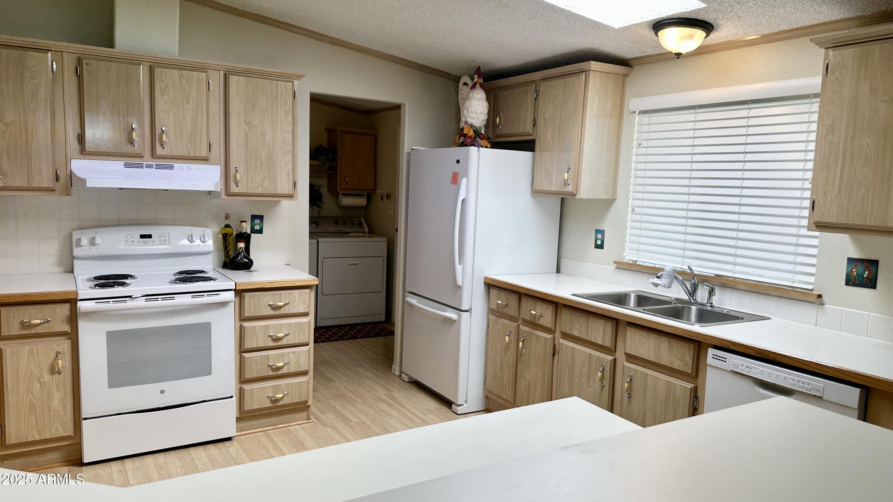 834 South Meridian Road, Unit 76 Apache Junction, AZ 85120 - Photo 38 of 50 a kitchen with a sink stove and refrigerator