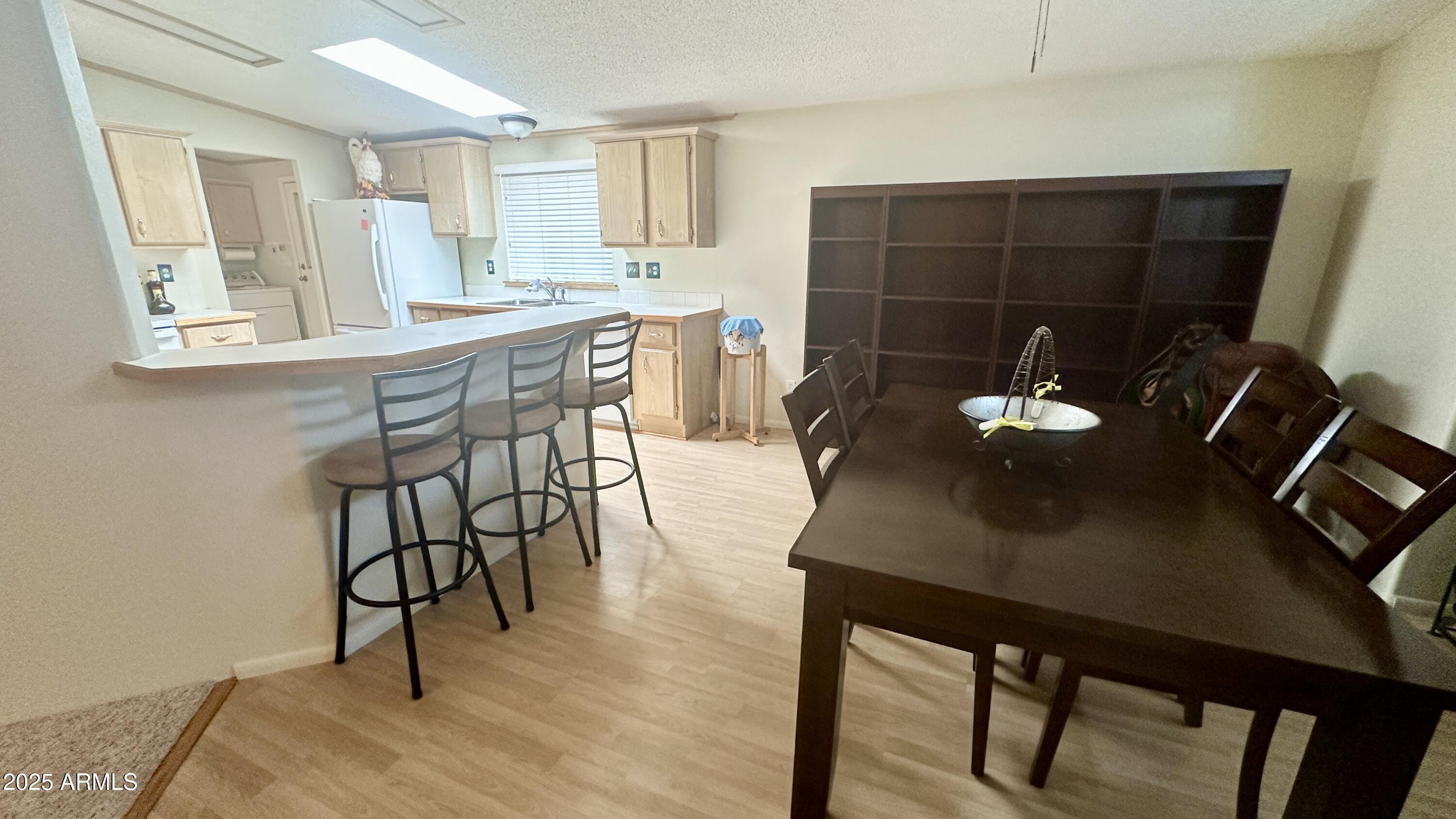 834 South Meridian Road, Unit 76 Apache Junction, AZ 85120 - Photo 40 of 50 a view of a dining room with furniture and wooden floor