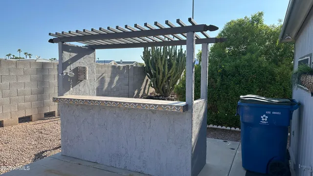 a spacious bathroom with a granite countertop sink a large mirror and a bathtub