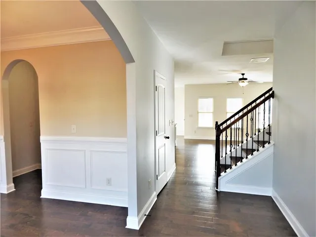 a view of entryway and hall with wooden floor