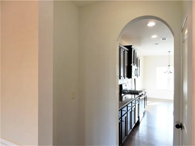 a kitchen with stainless steel appliances granite countertop a stove and a sink