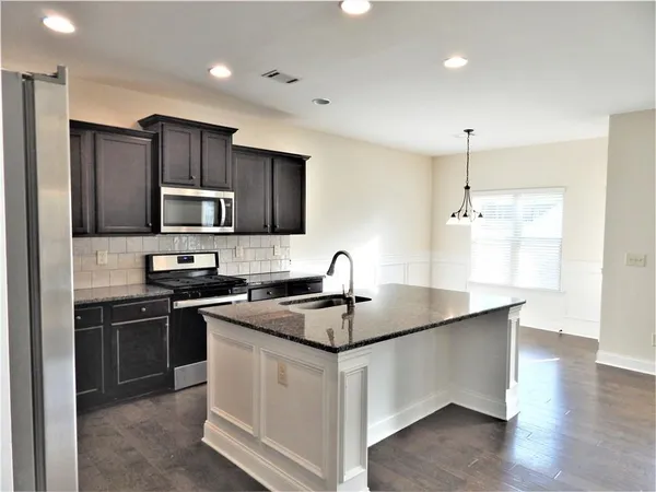 a bathroom with a double vanity sink mirror and toilet