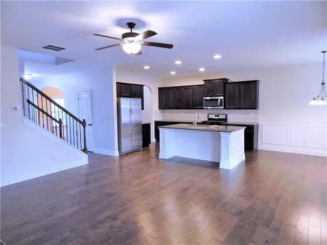 a view of a small space with wooden floor and a window