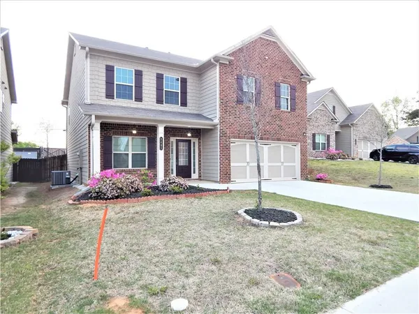 a front view of a house with a yard