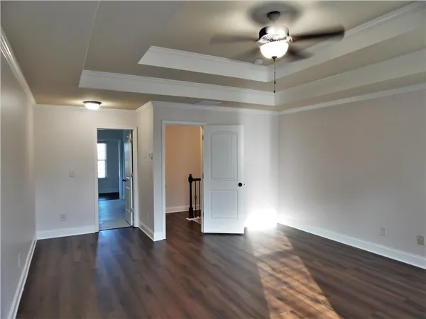 an empty room with wooden floor and window