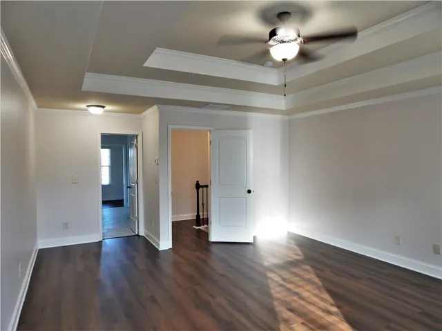 an empty room with wooden floor and window