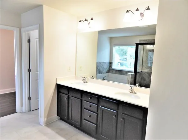 a view of staircase with railing and white walls