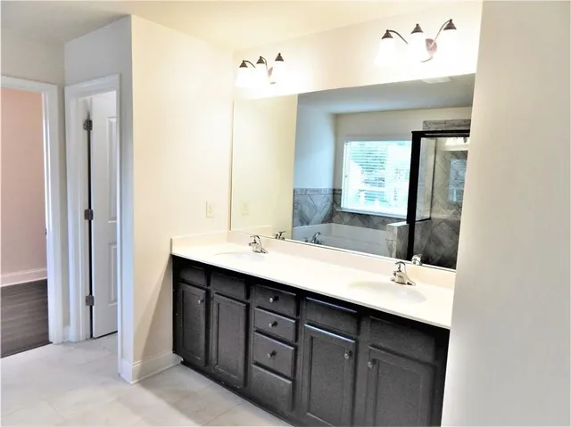 a view of staircase with railing and white walls