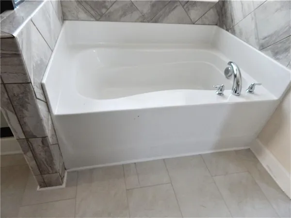 a view of a hallway with wooden floor and stairs