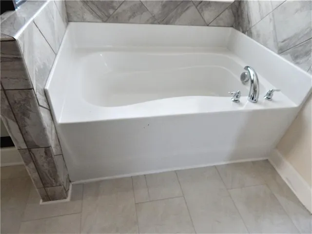 a view of a hallway with wooden floor and stairs