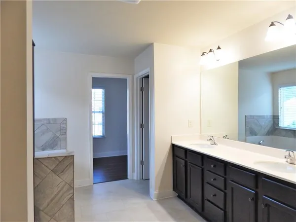 a view of a hallway with wooden floor and a window