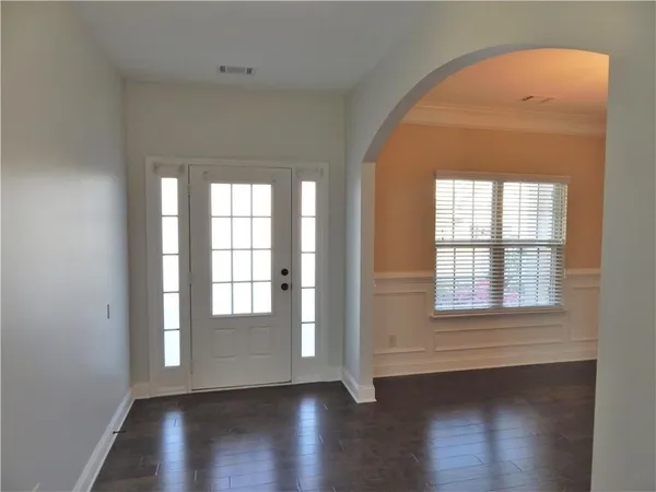 a view of a room with wooden floor windows and stairs