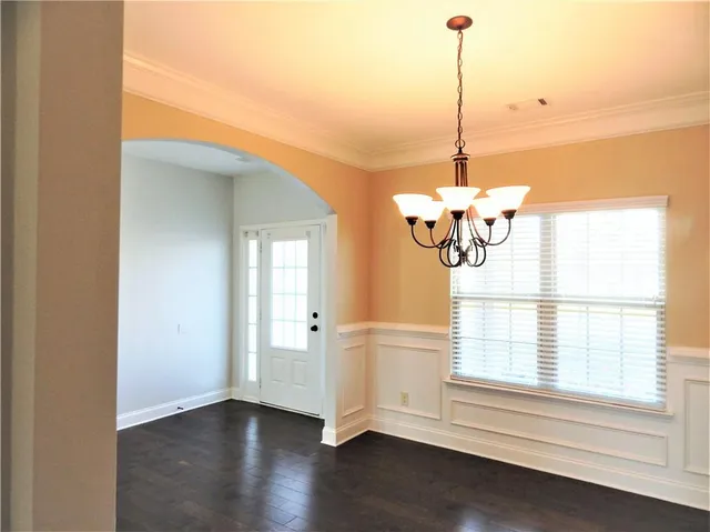 a view of a livingroom with wooden floor a ceiling fan and a fireplace