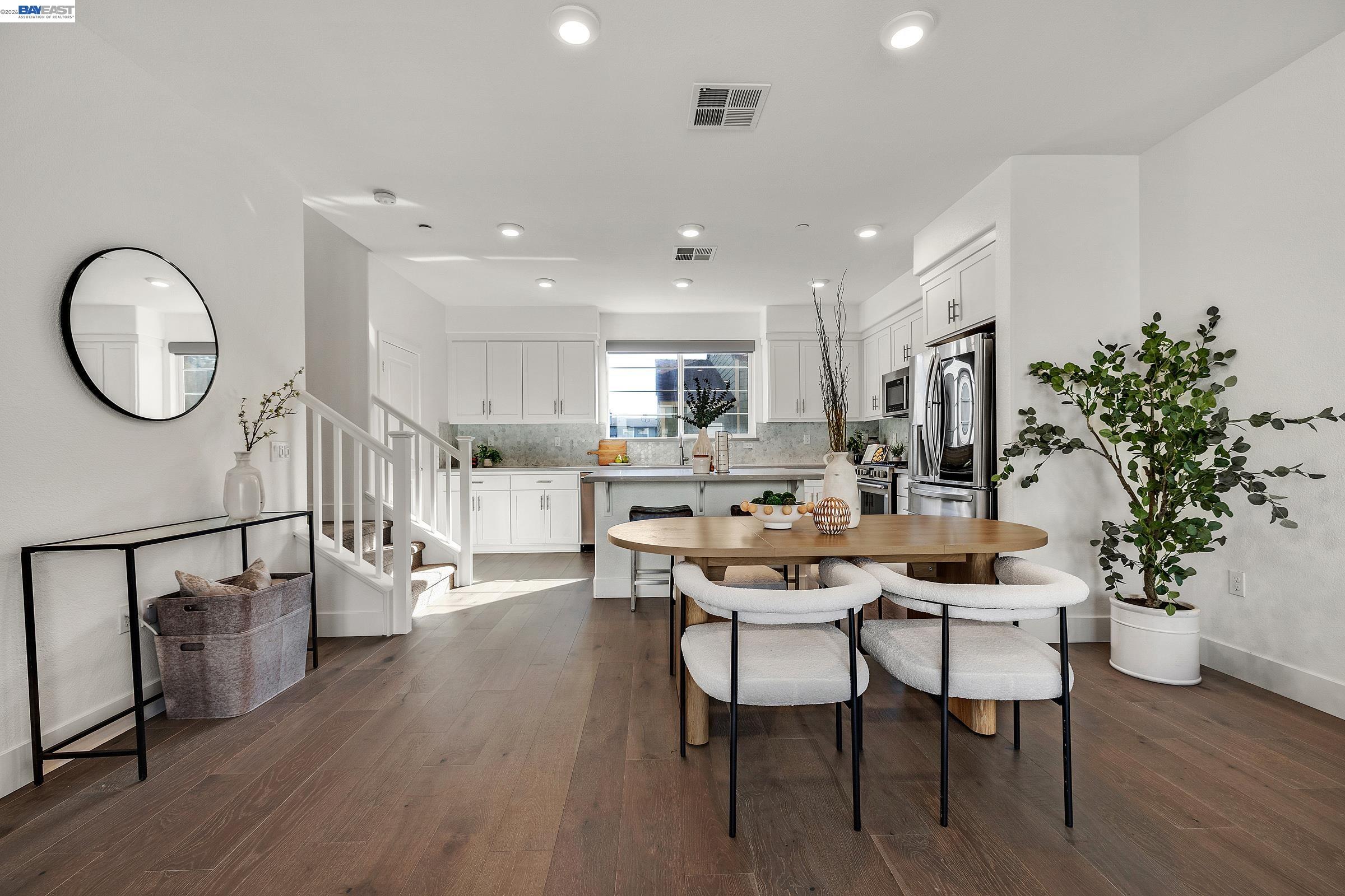 a dining room with furniture and wooden floor