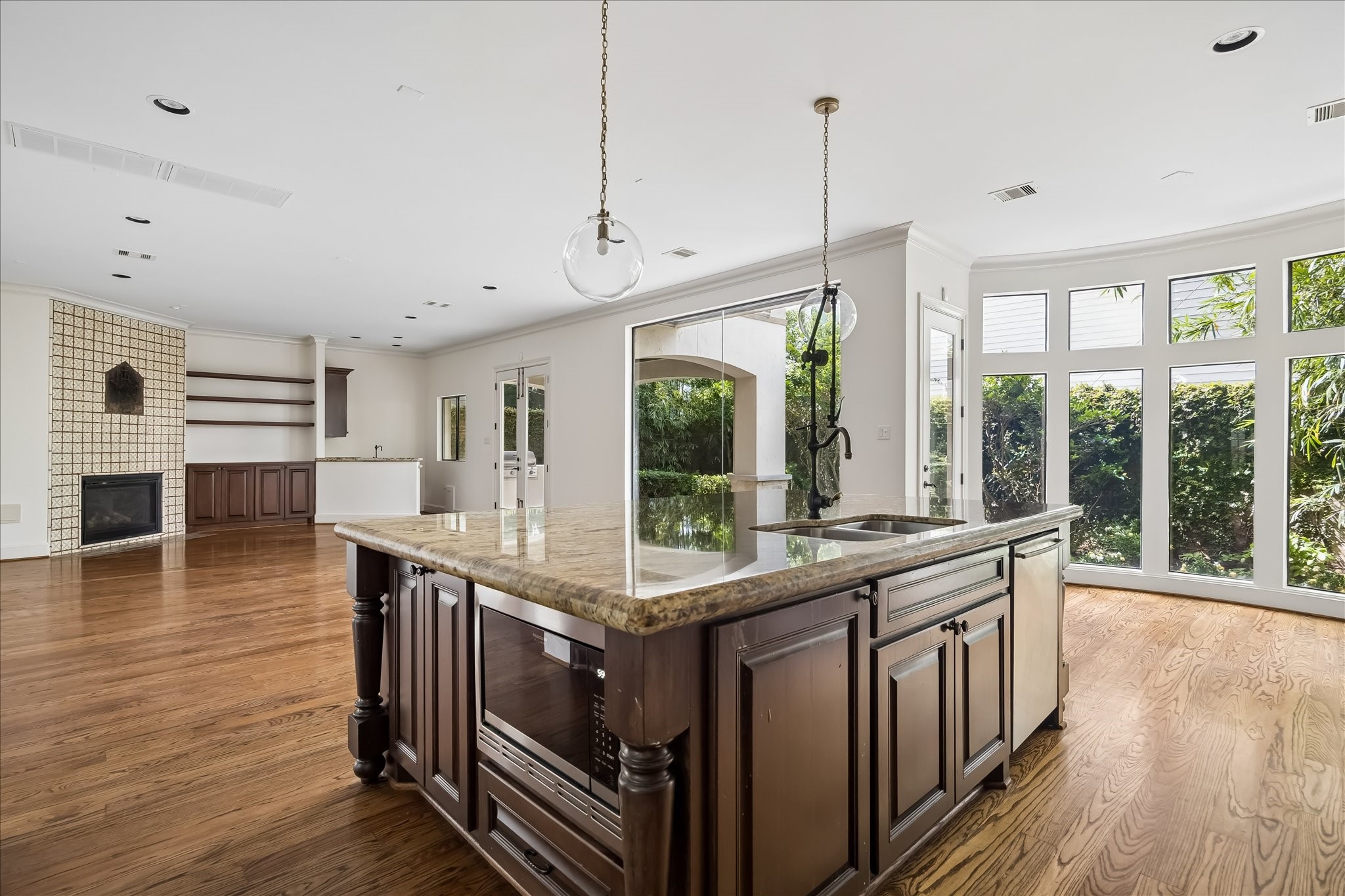 2246 Branard Street Houston, TX 77098 - Photo 11 of 40 Floor to ceiling windows and connected living spaces create a bright, inviting flow between the kitchen, breakfast area, and family room.