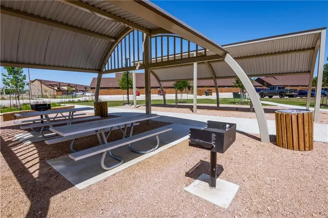 a view of a swimming pool with a patio and a patio