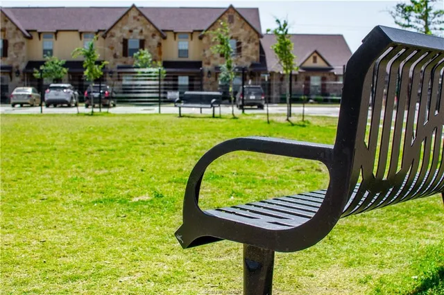 a view of swimming pool with outdoor seating and a garden