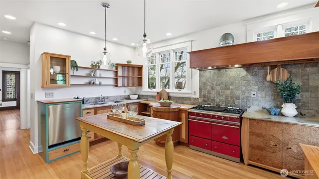 a kitchen with stainless steel appliances a sink stove and refrigerator