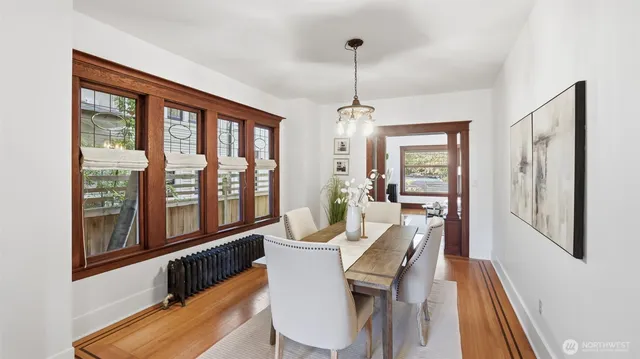 a view of a dining room with furniture window and wooden floor