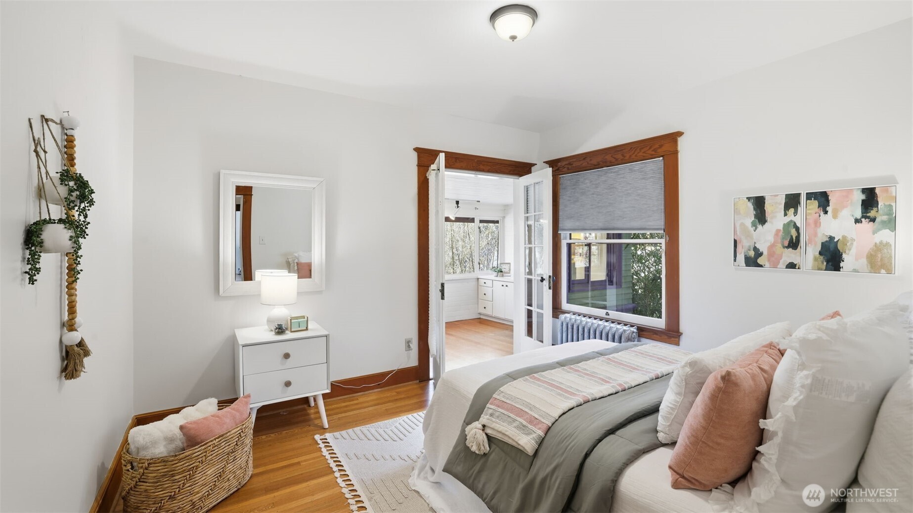 908 15th Avenue East Seattle, WA 98112 - Photo 22 of 37 a bedroom with a bed and glass windows