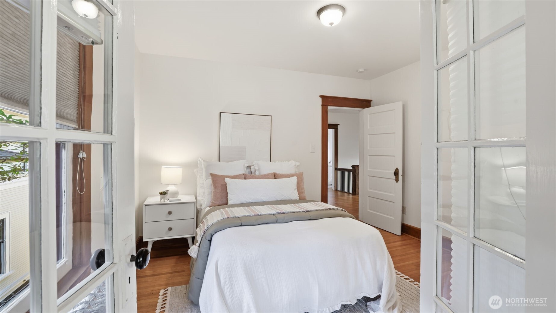 908 15th Avenue East Seattle, WA 98112 - Photo 23 of 37 a bedroom with a bed and a cabinets
