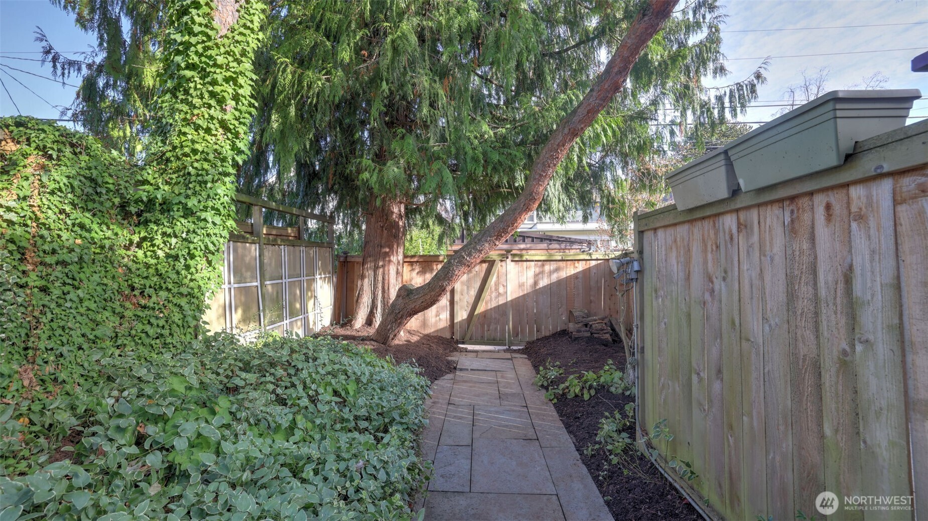 908 15th Avenue East Seattle, WA 98112 - Photo 36 of 37 a view of a pathway of a house with wooden fence