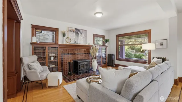 a living room with furniture large window and fireplace