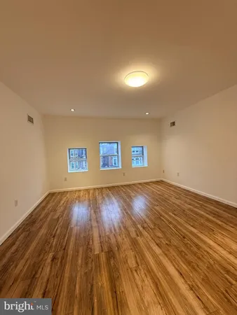 a view of an empty room and wooden floor