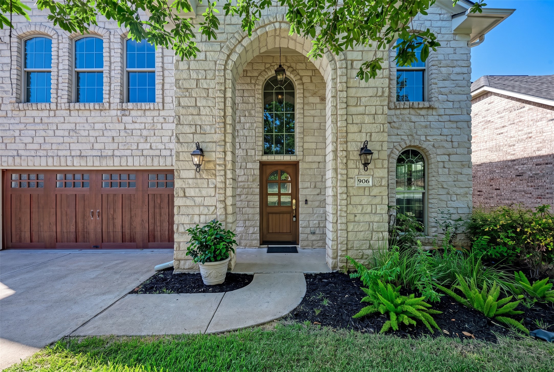 906 Antelope Ridge Cedar Park, TX 78613 - Photo 3 of 40 An arched entryway introduces the textured stone facade of this two-story residence.