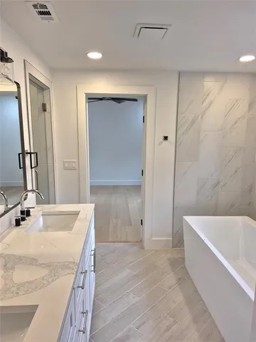 a bathroom with a bathtub and a sink