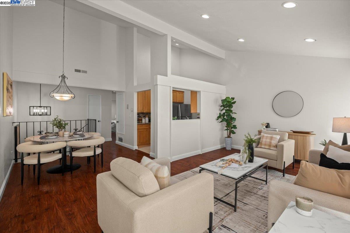 2253 Kalenda Common Fremont, CA 94539 - Photo 17 of 38 a living room with furniture kitchen view and a wooden floor