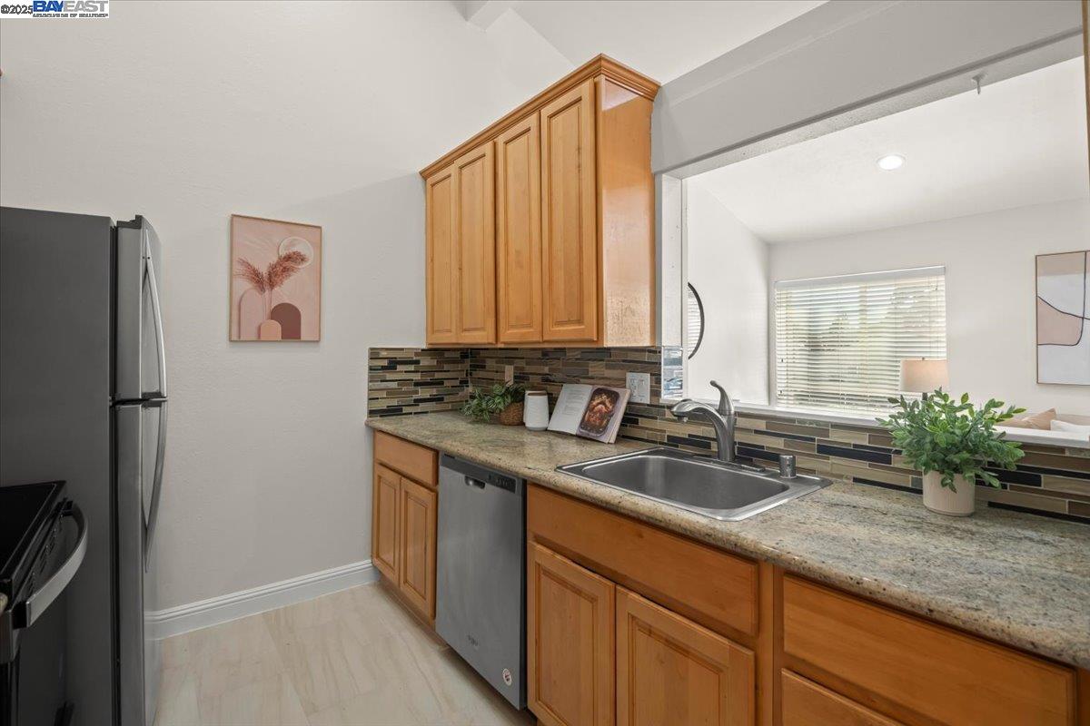 2253 Kalenda Common Fremont, CA 94539 - Photo 21 of 38 a kitchen with sink cabinets and refrigerator