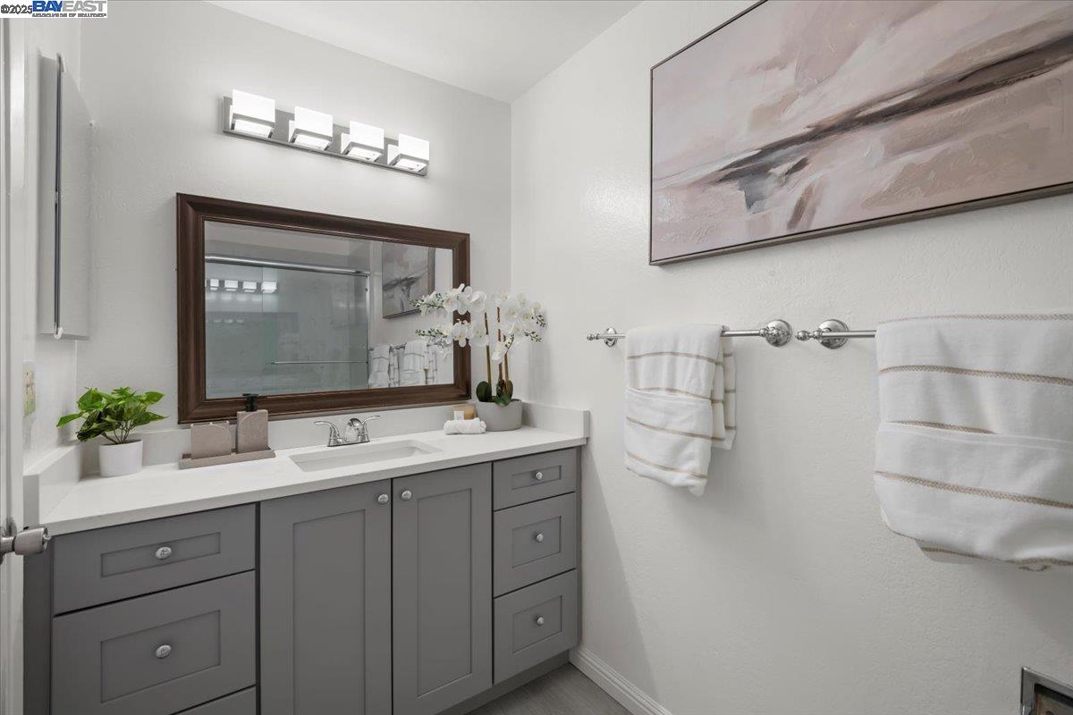 2253 Kalenda Common Fremont, CA 94539 - Photo 26 of 38 a bathroom with a double vanity sink and a mirror