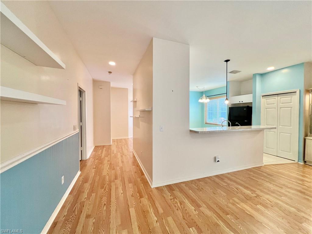 443 Crossfield Circle, Unit 74 Naples, FL 34104 - Photo 14 of 45 a view of a kitchen with wooden floor and a sink