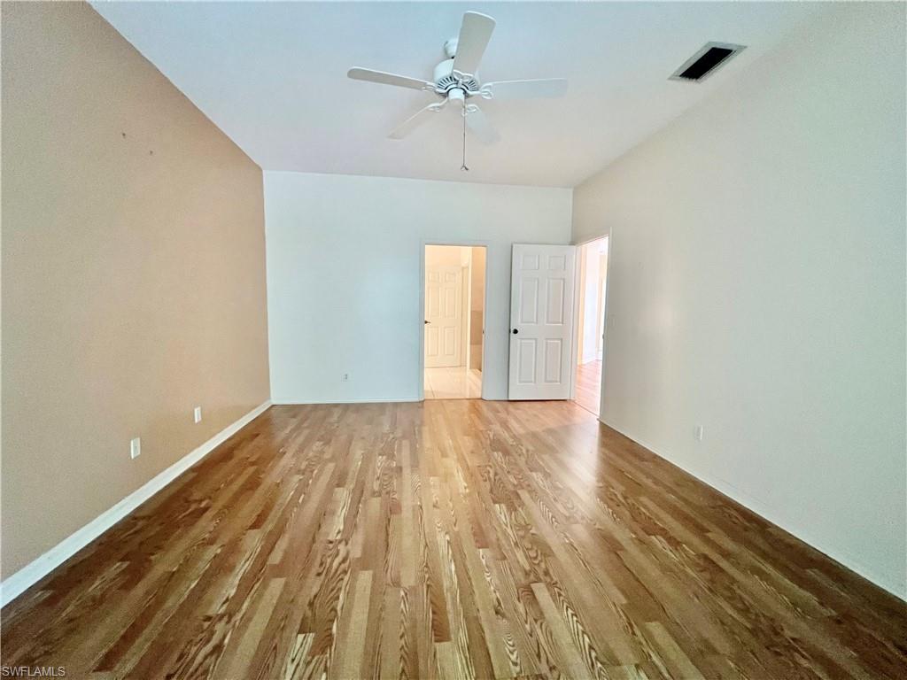 443 Crossfield Circle, Unit 74 Naples, FL 34104 - Photo 17 of 45 wooden floor in an empty room with a window