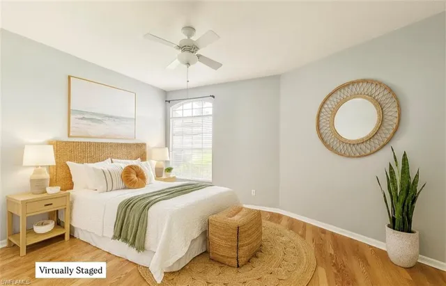 a bedroom with a bed and a potted plant