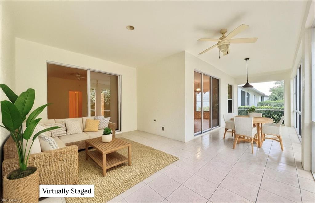 443 Crossfield Circle, Unit 74 Naples, FL 34104 - Photo 19 of 45 a living room with furniture potted plant and a large window