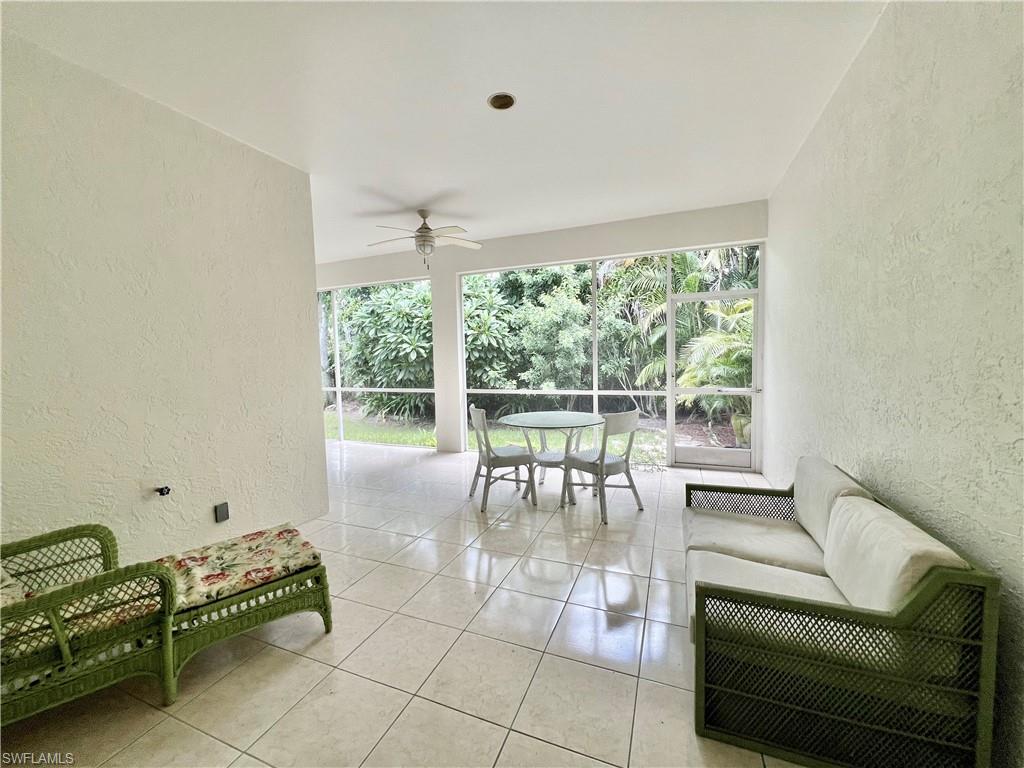 443 Crossfield Circle, Unit 74 Naples, FL 34104 - Photo 21 of 45 a living room with furniture and a large window