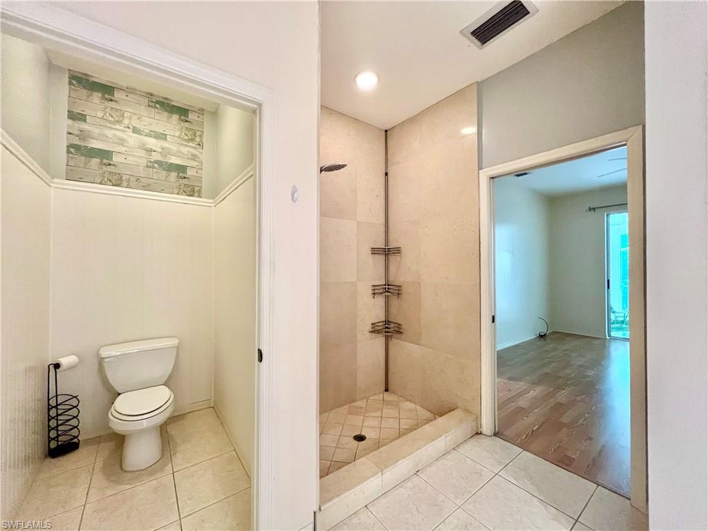 443 Crossfield Circle, Unit 74 Naples, FL 34104 - Photo 30 of 45 a bathroom with a toilet and a shower