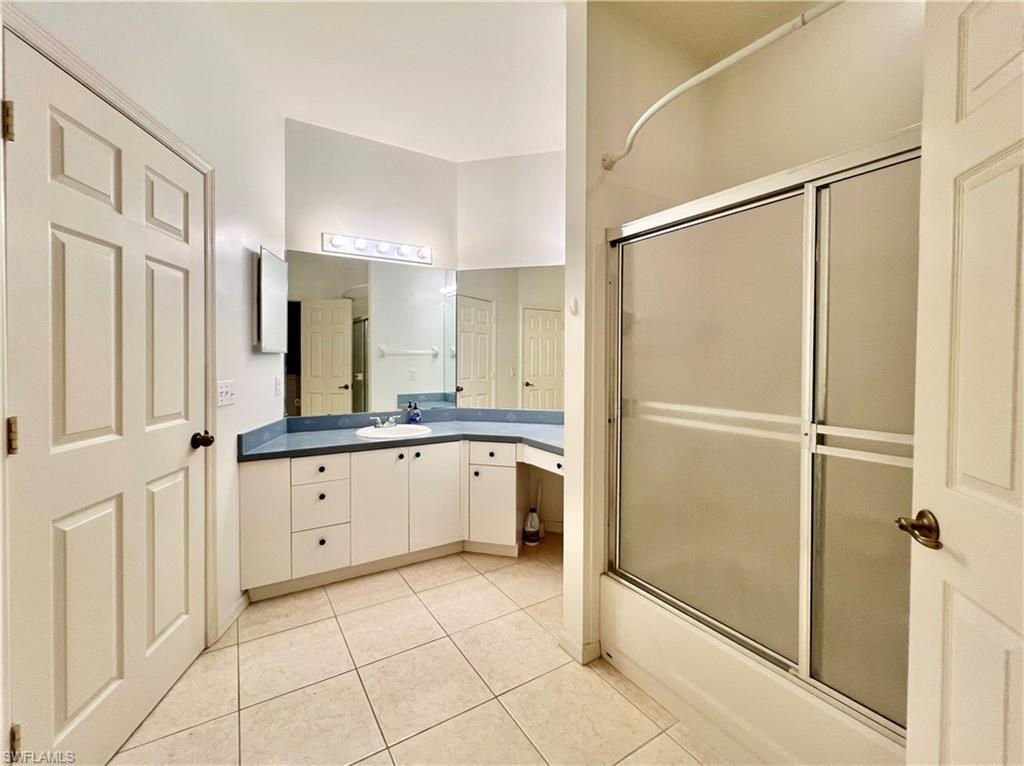 443 Crossfield Circle, Unit 74 Naples, FL 34104 - Photo 34 of 45 a large white bathroom with a granite countertop sink mirror and a