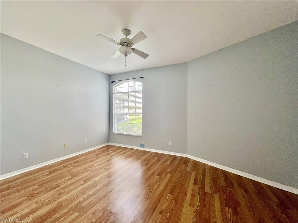 443 Crossfield Circle, Unit 74 Naples, FL 34104 - Photo 35 of 45 wooden floor in an empty room with a window