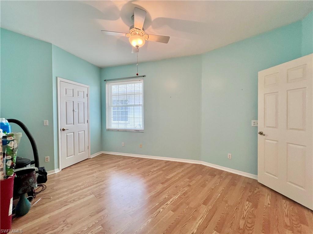443 Crossfield Circle, Unit 74 Naples, FL 34104 - Photo 38 of 45 a view of livingroom with hardwood floor and a ceiling fan