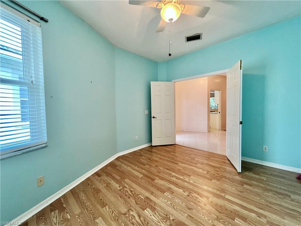 443 Crossfield Circle, Unit 74 Naples, FL 34104 - Photo 39 of 45 a view of an empty room with wooden floor and a window