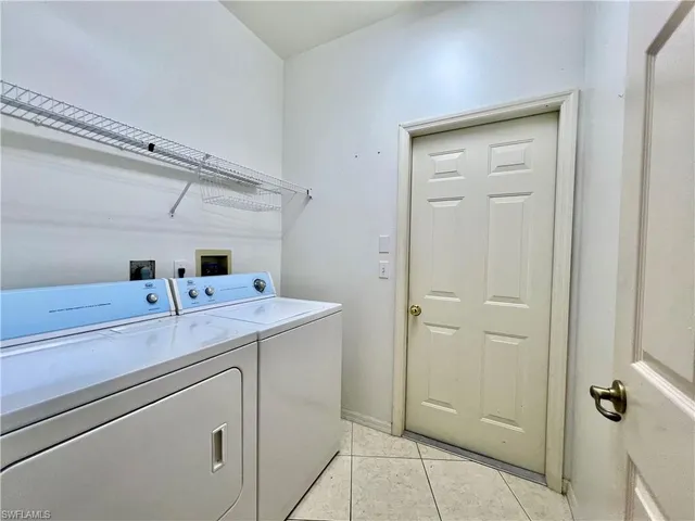 a utility room with cabinets washer and dryer